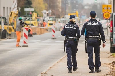 Two police officers walking near construction site